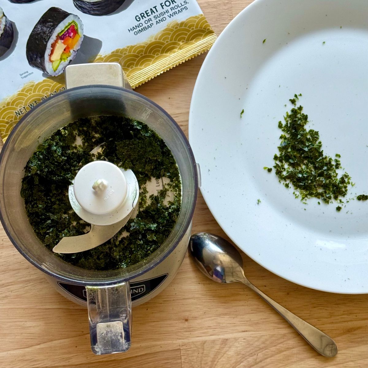 A food processor and plate with ground nori.