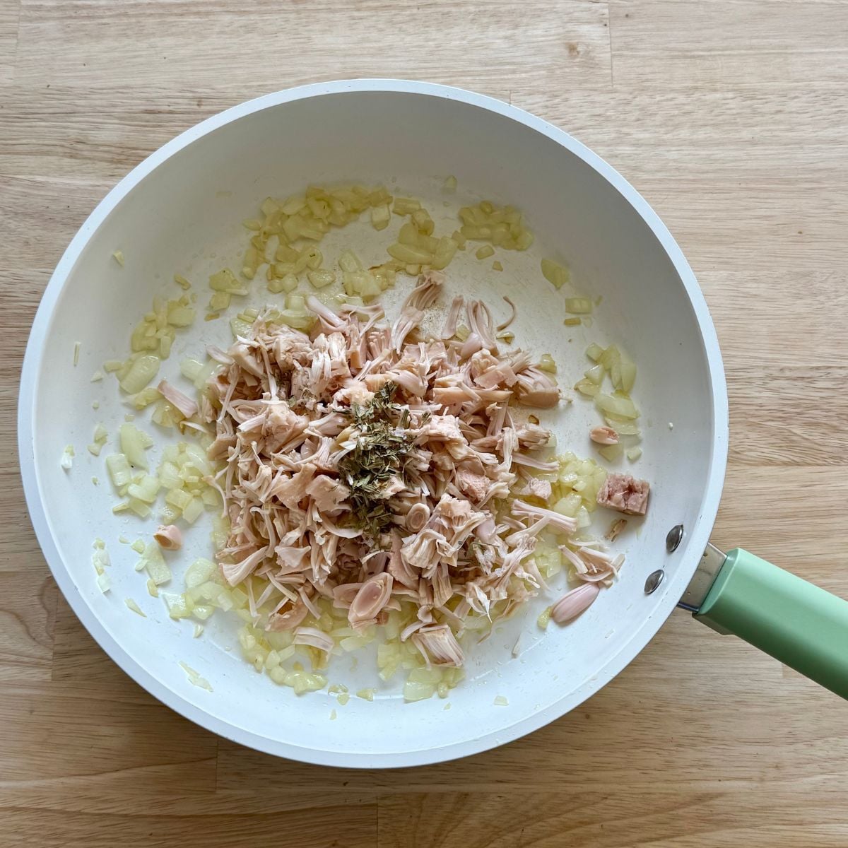 A skillet with jackfruit and onions.