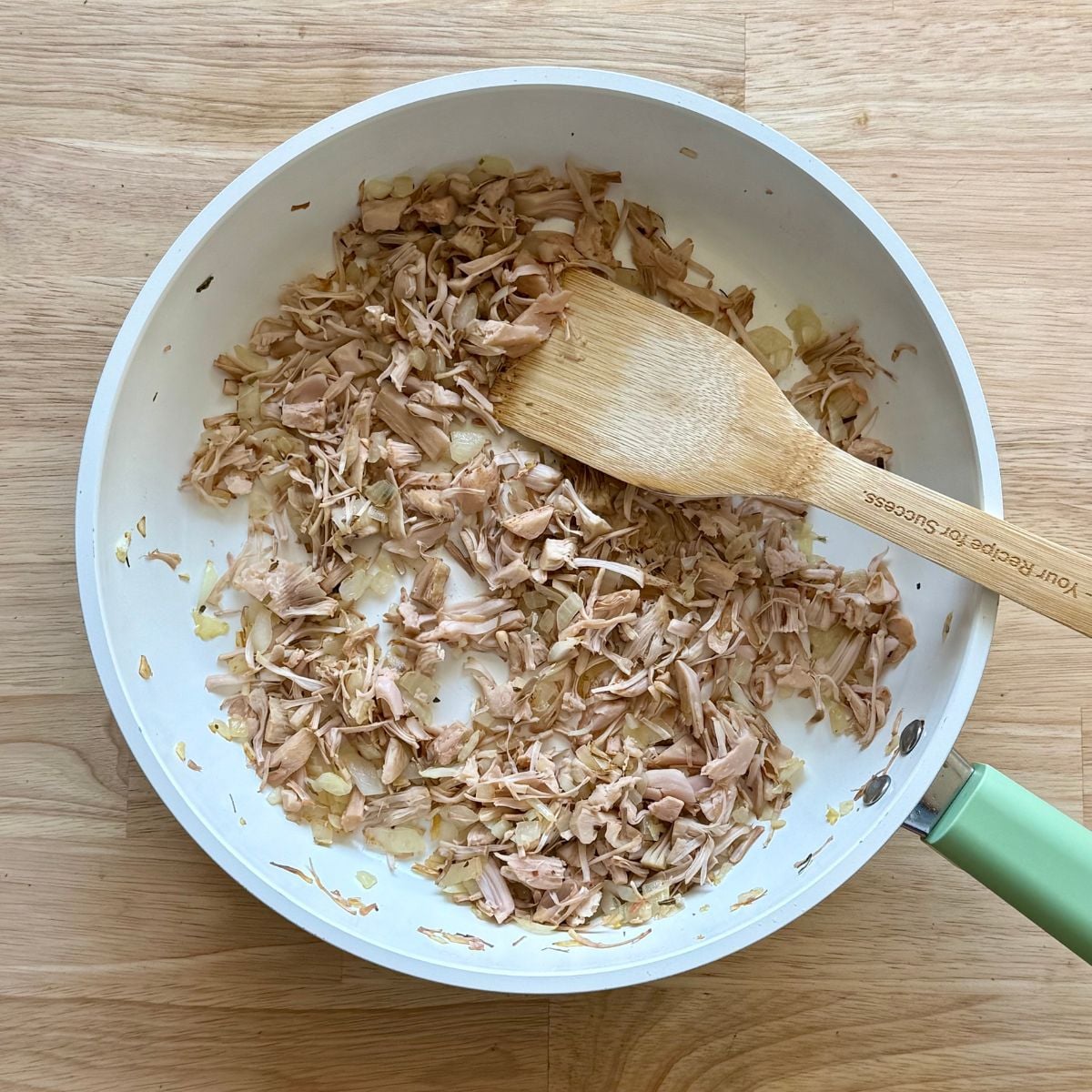 A skillet with jackfruit and onions.
