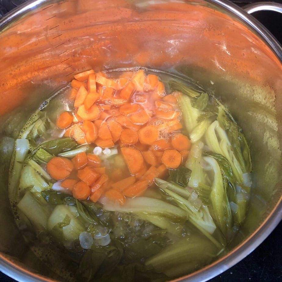 carrots and bok choy in tom yum broth