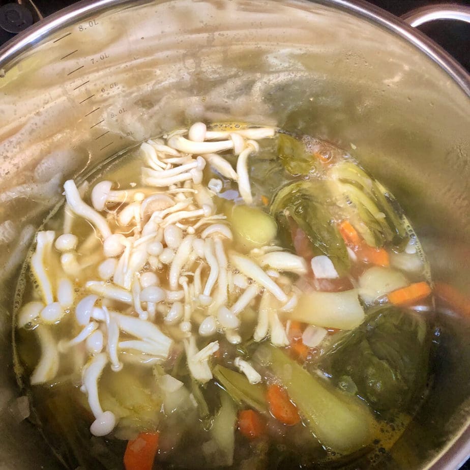 Shemeji mushrooms added to tom yum broth