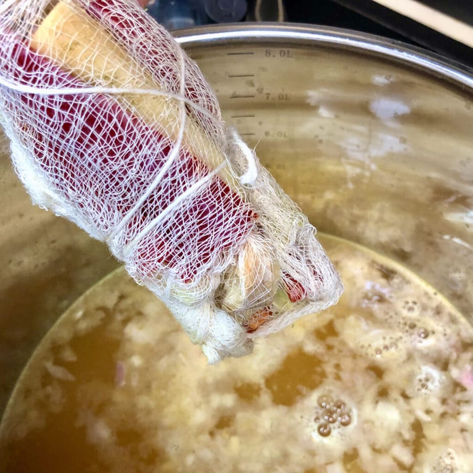 herb sachet into tom yum broth