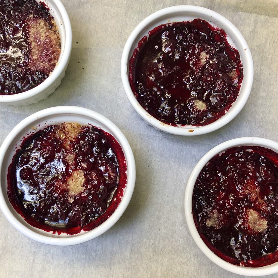 Ramekins with Boysenberry crumble hot out of the oven.