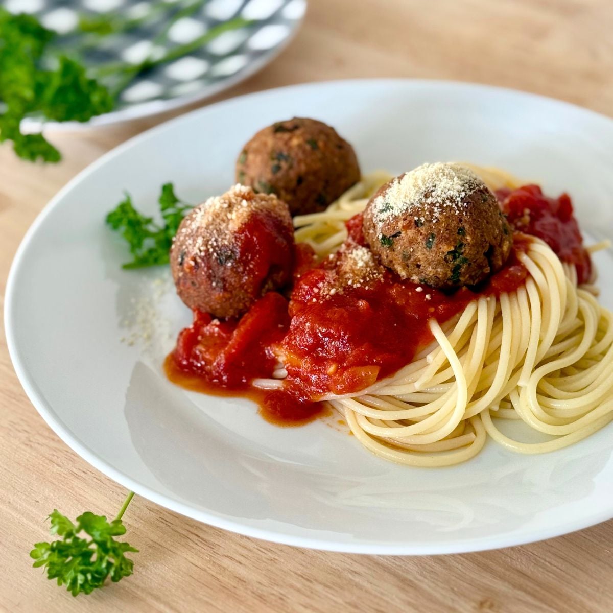 A plate of spaghetti topped with vegan meatless meatballs and marinara.