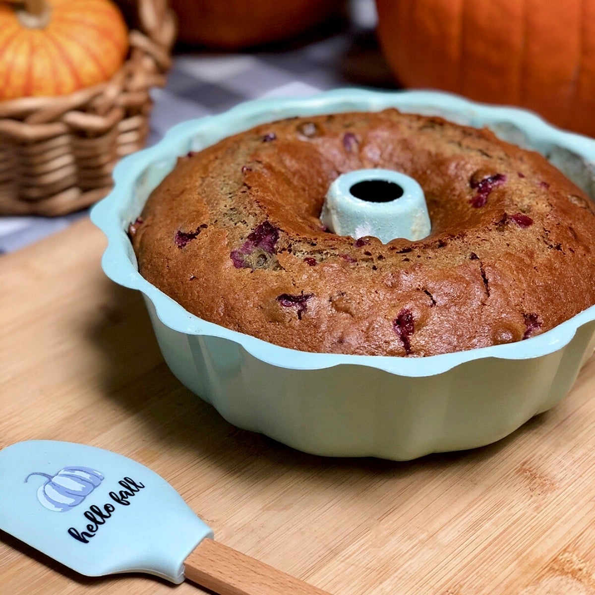 A vegan old fashioned applesauce cake with cranberries inside a Bundt pan.