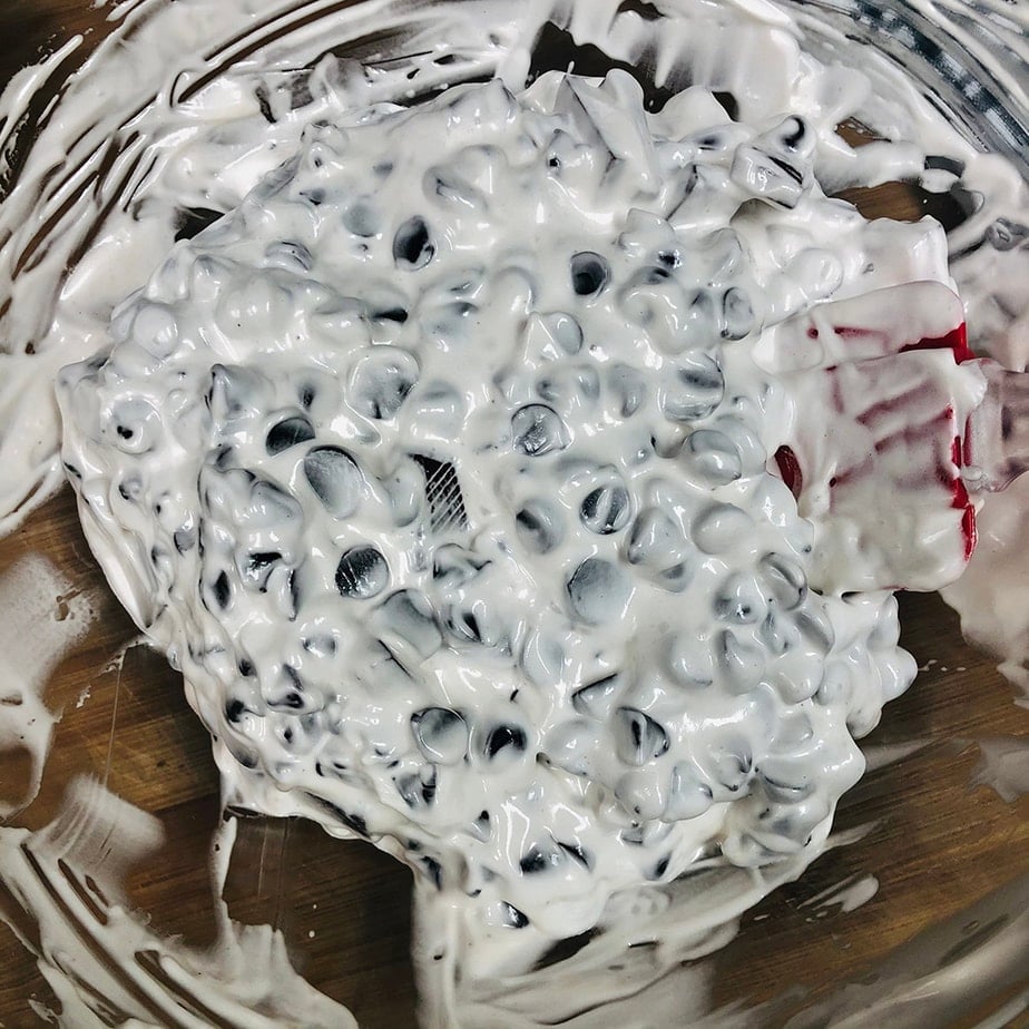 Vegan marshmallow fluff stirred into chocolate and vanilla for vegan fudge.