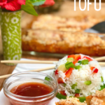 A plate with vegan sweet and sour macadamia crusted tofu, served with a side of pineapple rice.