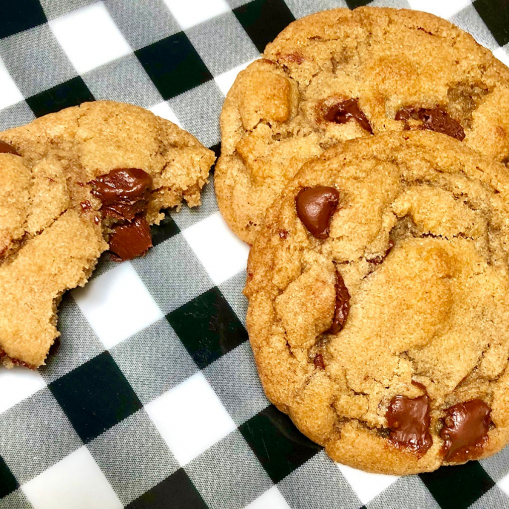 A black and white plate with vegan chocolate chip cookies.
