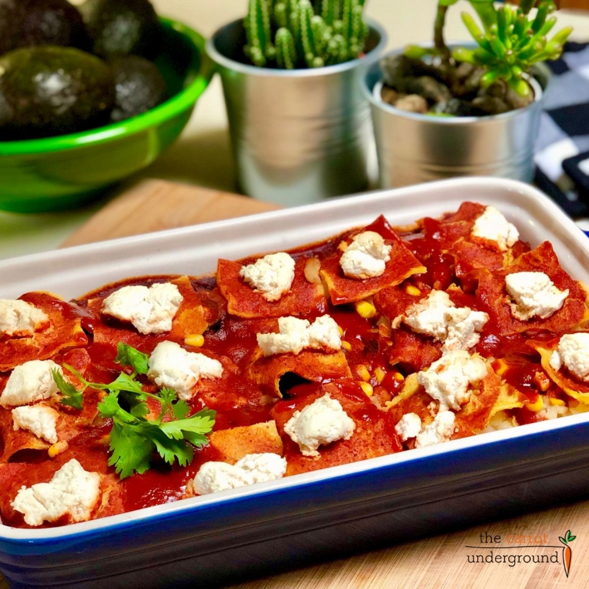 A rectangular ceramic baking dish filled with vegan potato enchilada casserole.