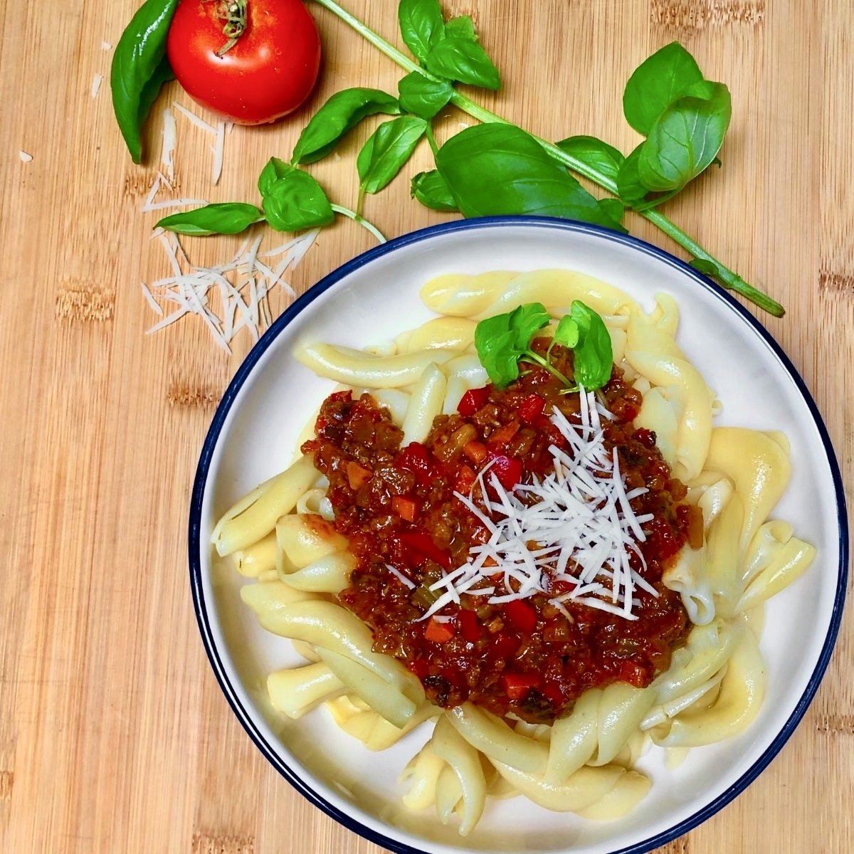A bowl of pasta topped with vegan Bolognese sauce.