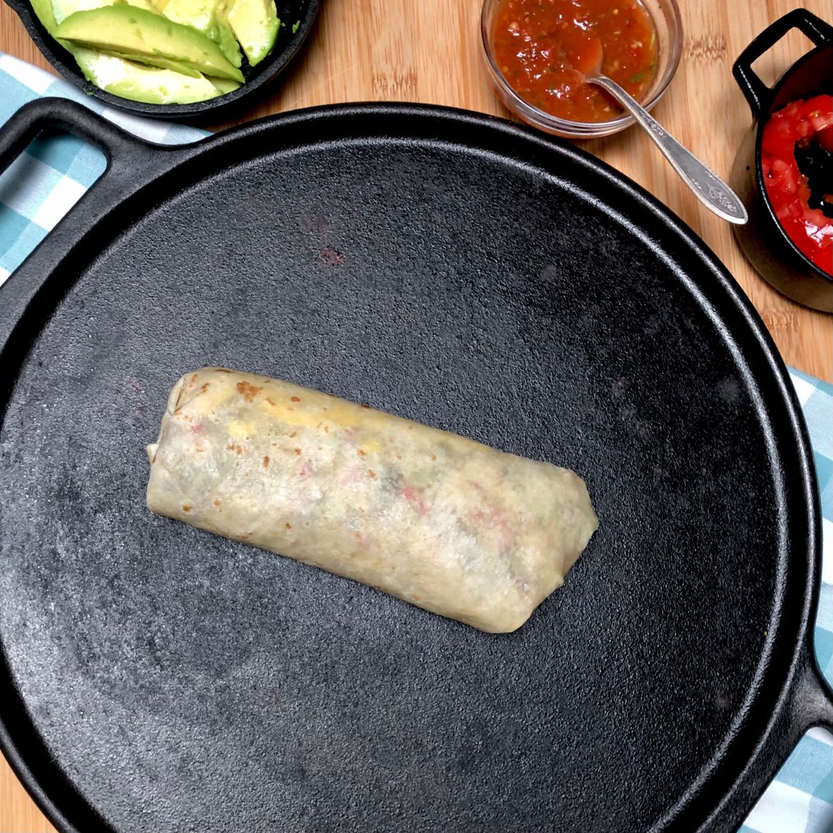 A vegan California breakfast burrito on a cast iron pan.