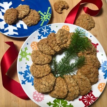 A decorative holiday plate arranged with homemade oatmeal cookies.