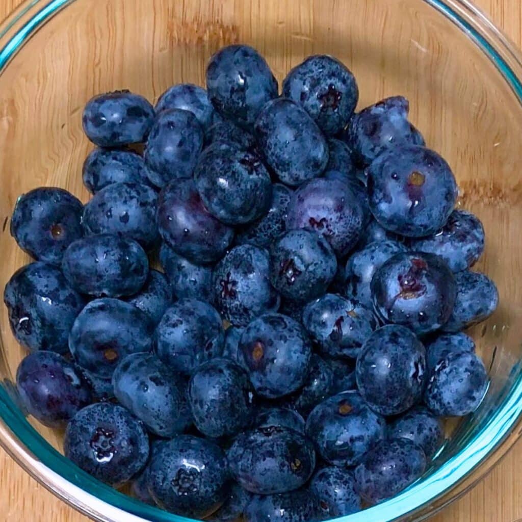 Fresh blueberries in a glass bowl.
