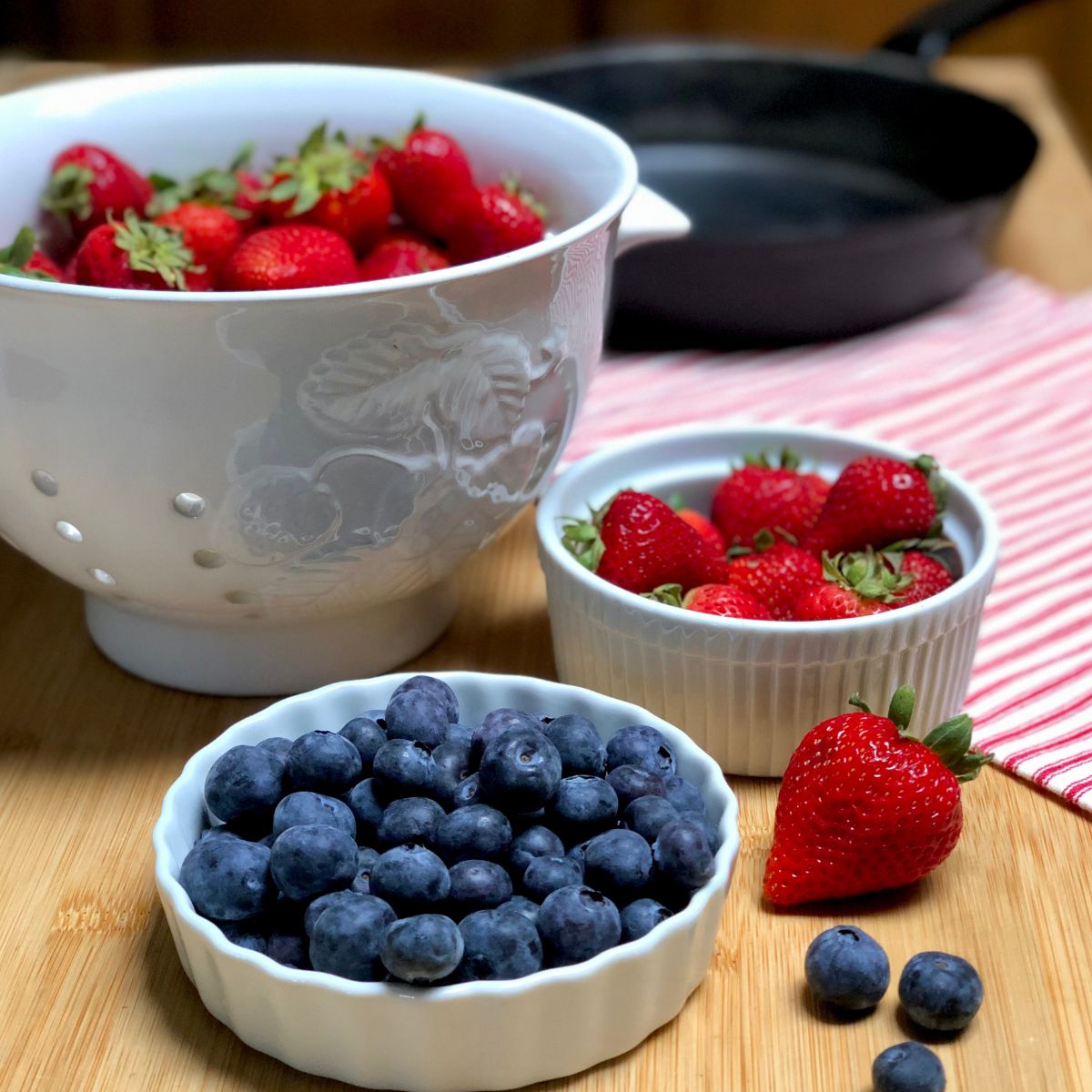 Fresh strawberries and blueberries in bowls.