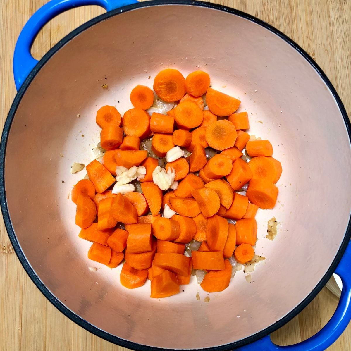 Carrots and onion in a soup pot.