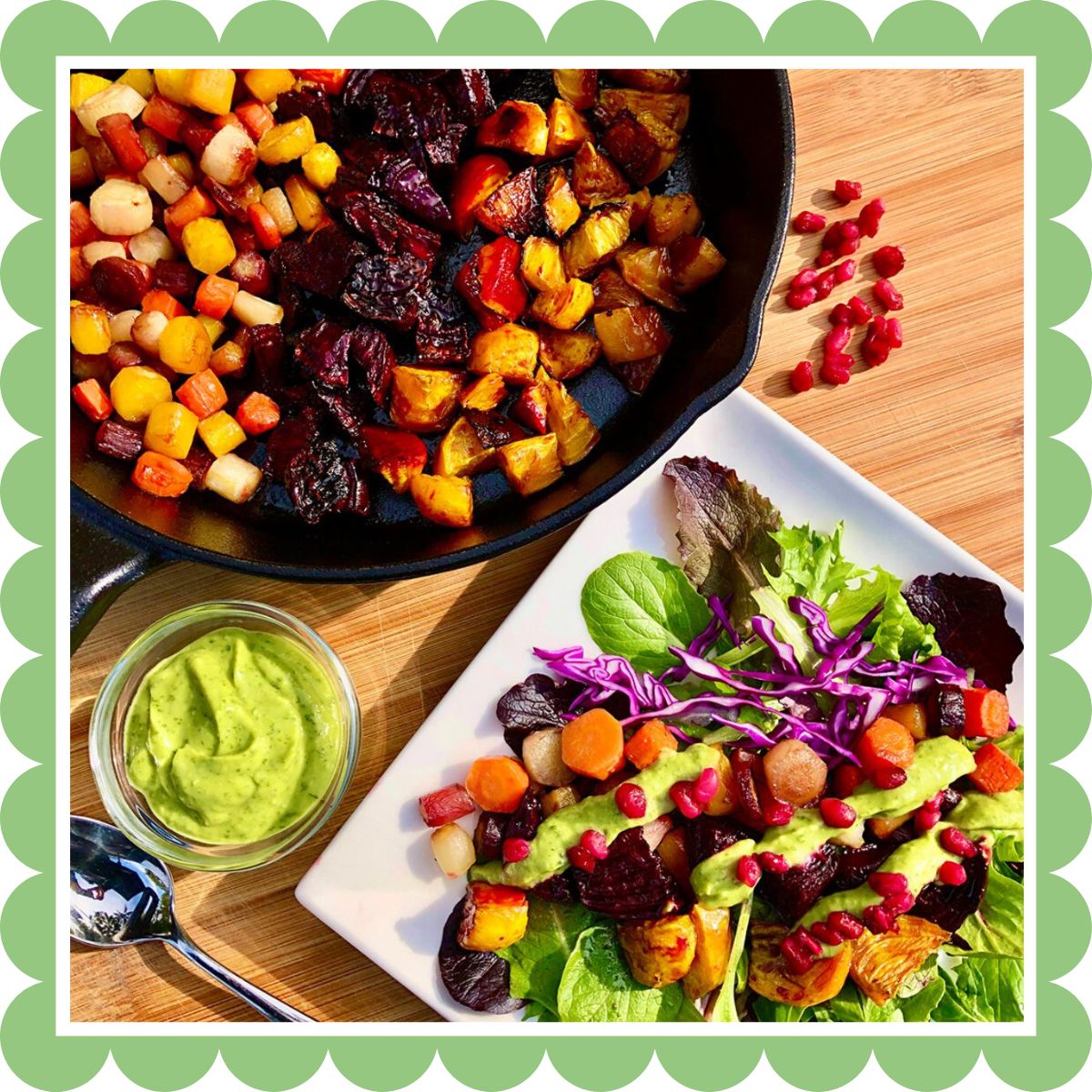 Roasted rainbow carrots and beets in a skillet  and plated with salad greens, avocado basil dressing, and pomegranate seeds.