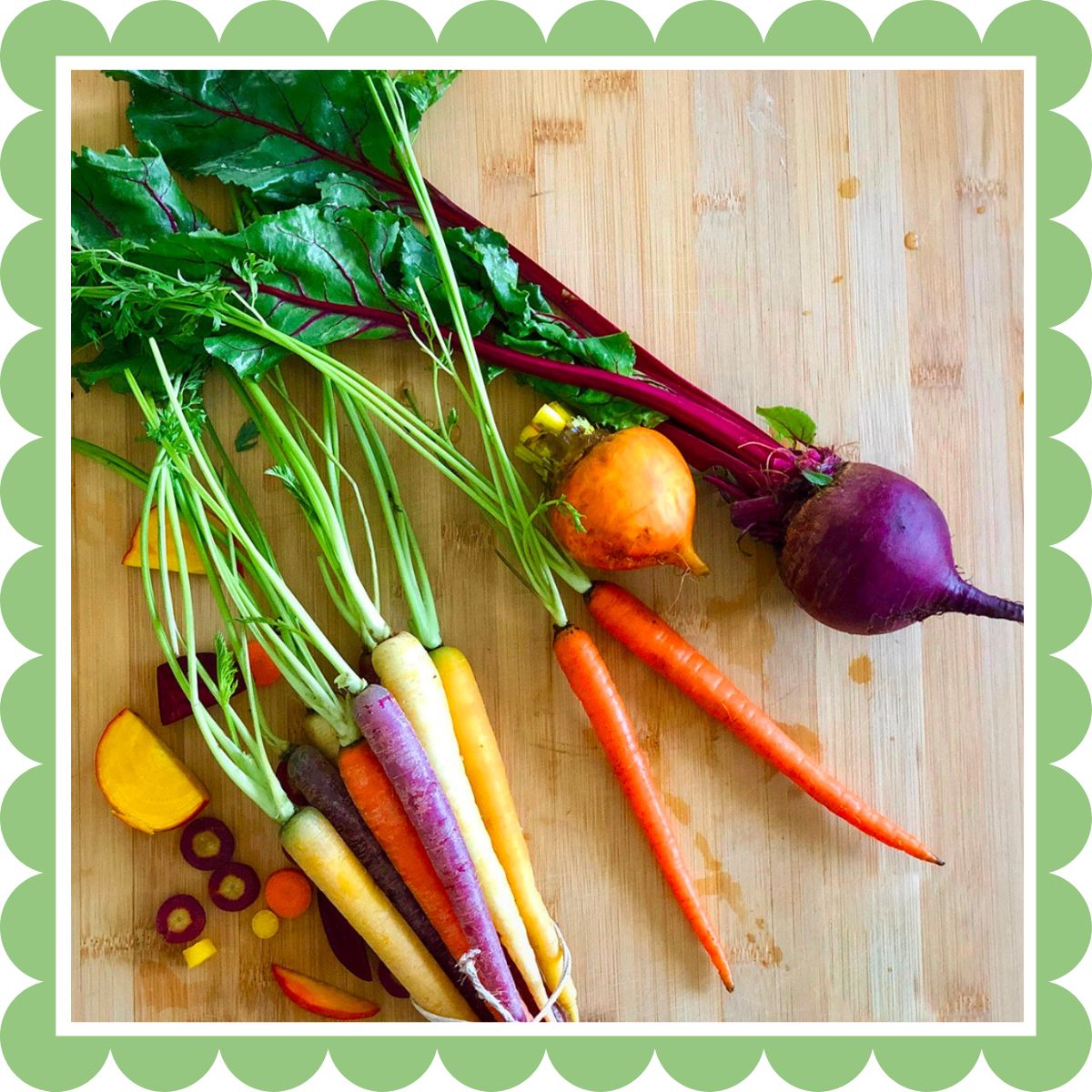 Fresh rainbow carrots and beets on a cutting board.