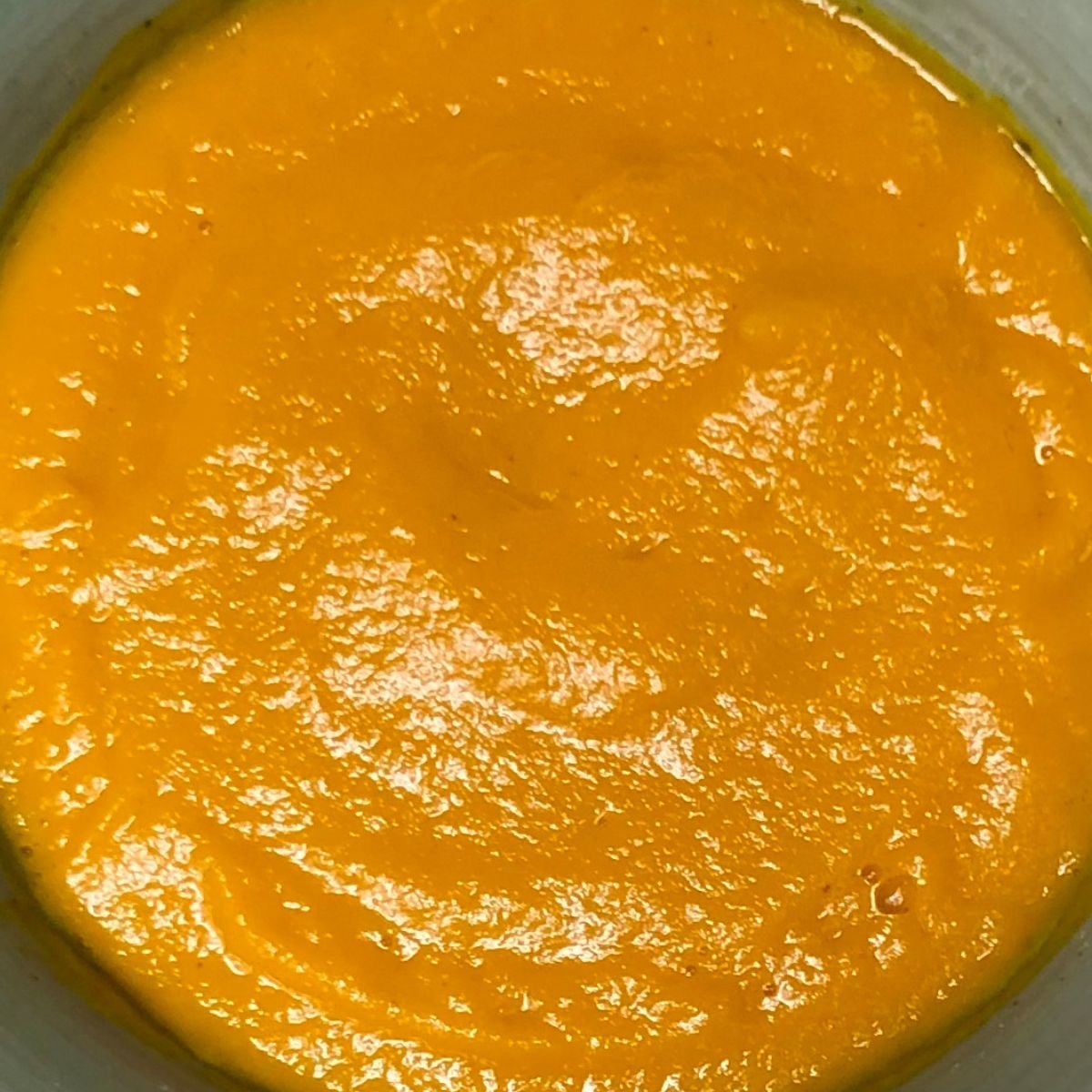 Vegan carrot ginger soup inside a bowl.
