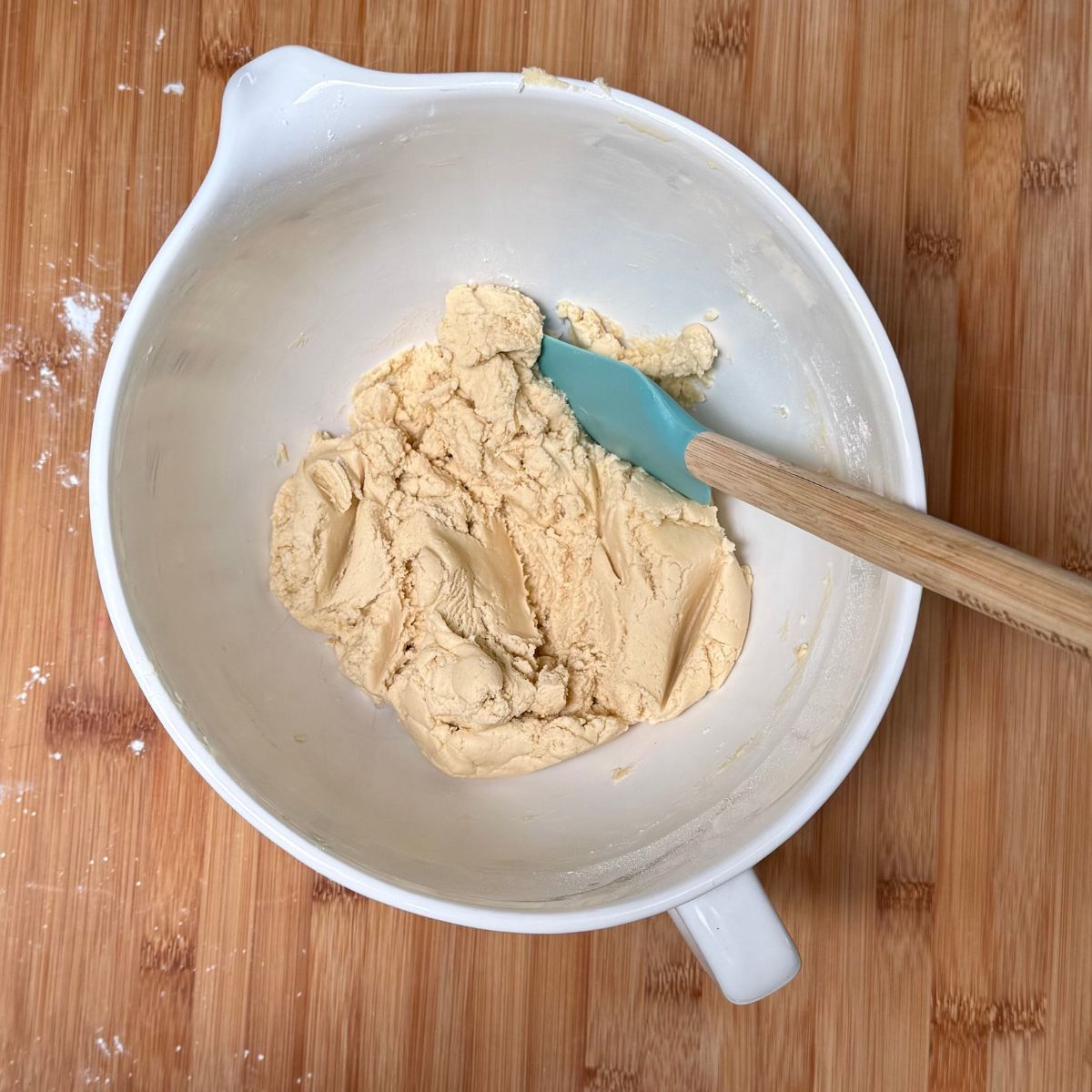 A mixing bowl filled with vegan shortbread cookie dough.