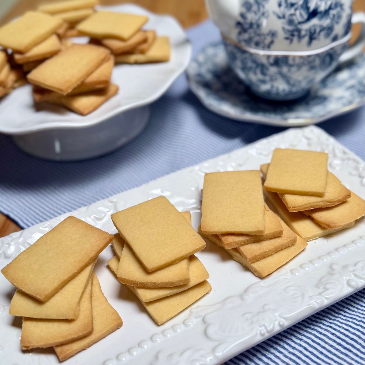 A plate of homemade vegan shortbread cookies in stacks.