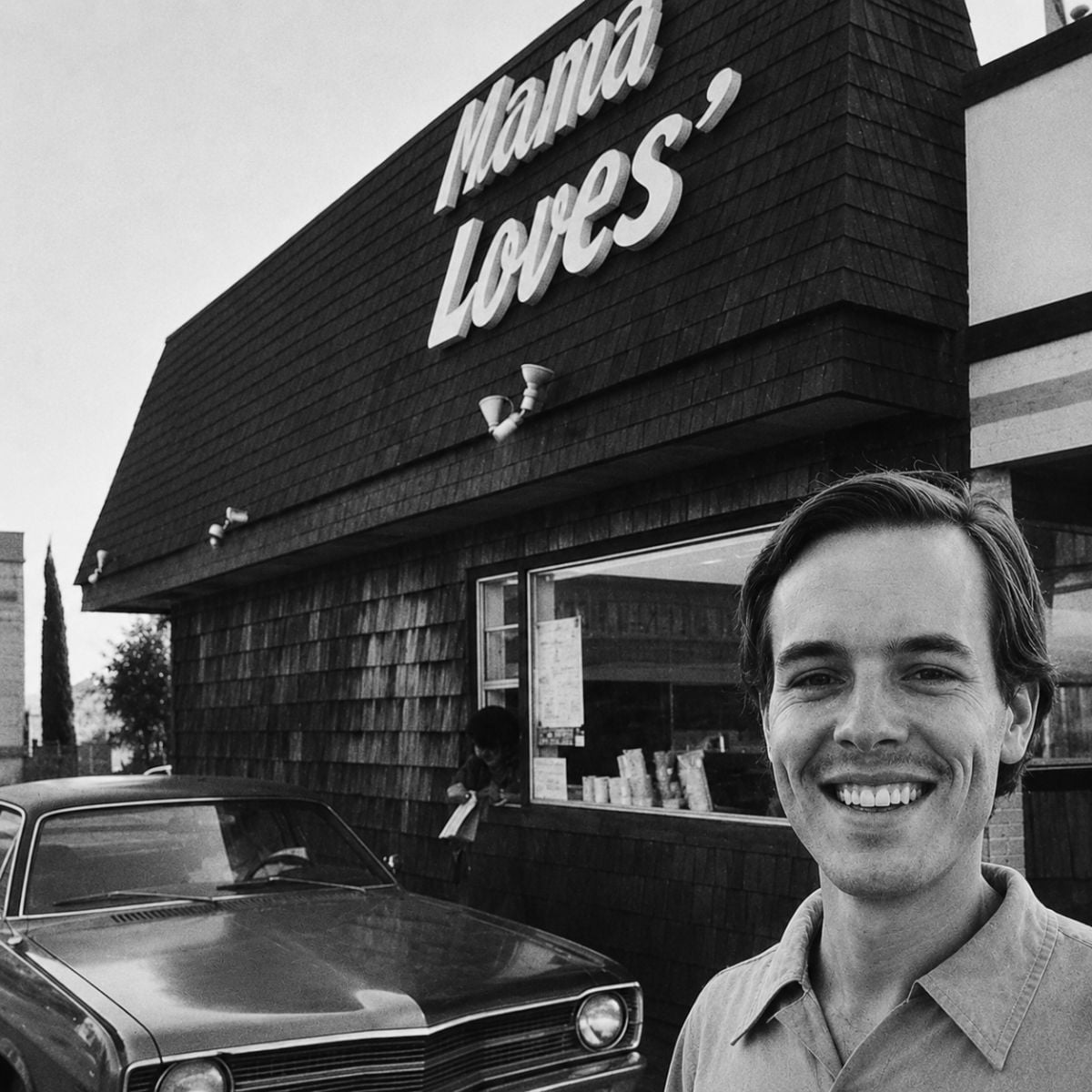 Scott Edwards, founder of Mama Love's natural food drive-in restaurants standing near the drive-up window outside the restaurant in San Diego.