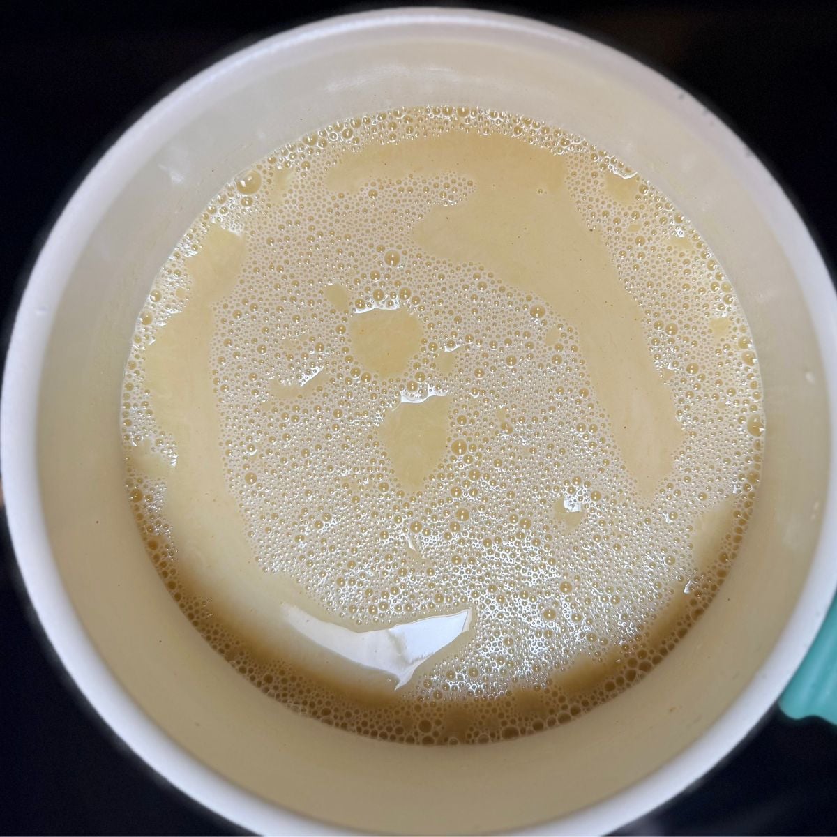 A sauce pan with uncooked filling for vegan lemon bars.