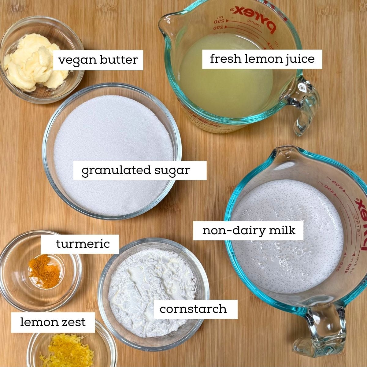 Ingredients in dishes for Classic Vegan Lemon Bar filling including lemon juice, granulated sugar, non-dairy milk, cornstarch, lemon zest, vegan butter, and turmeric.
