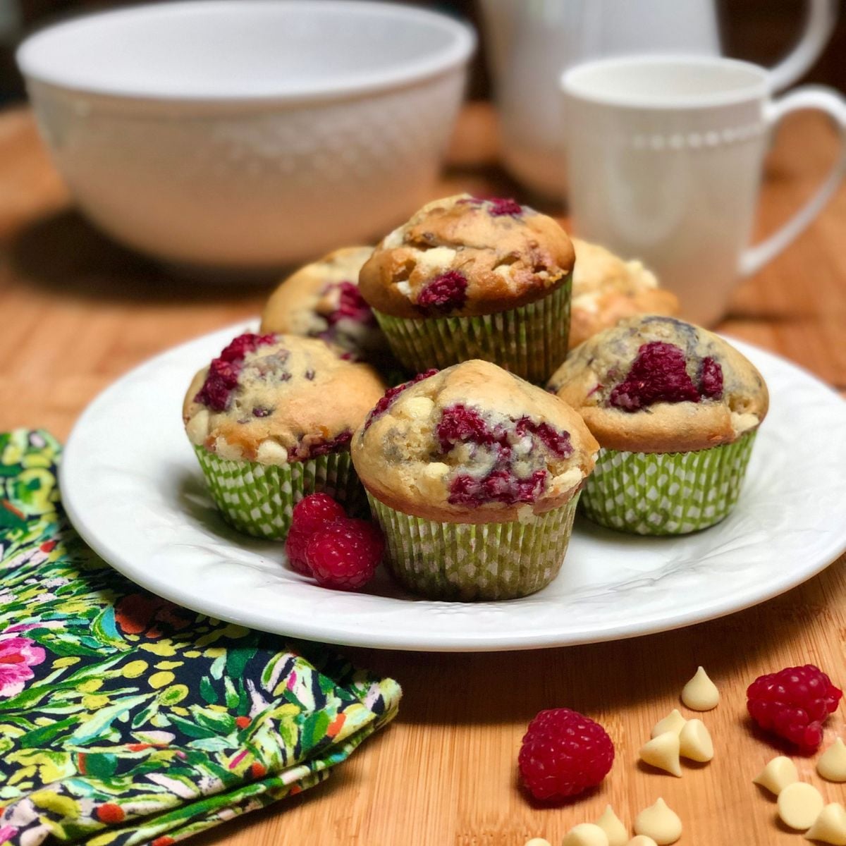 Vegan raspberry white chocolate muffins on a plate.